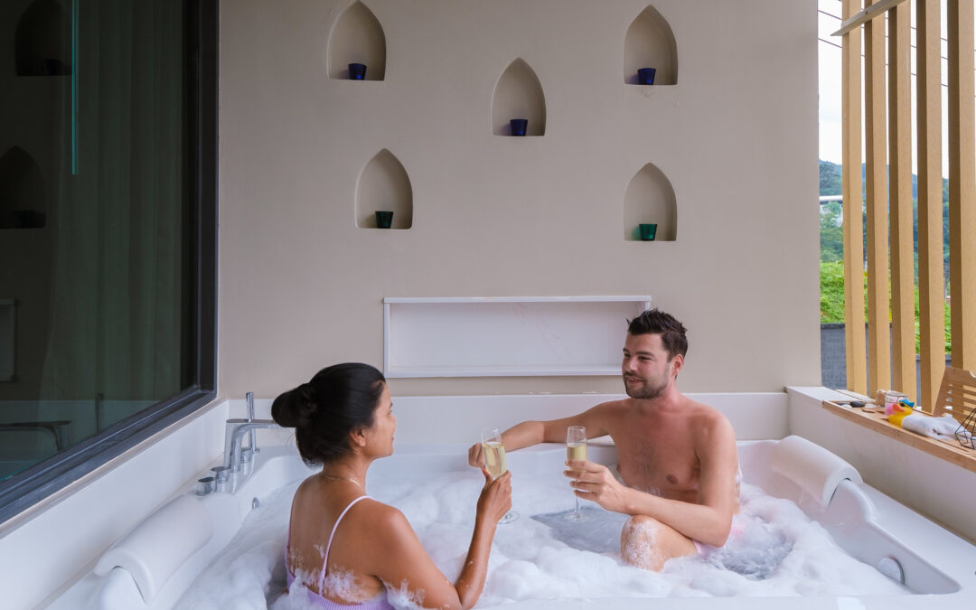 couple with drinks in hot tub